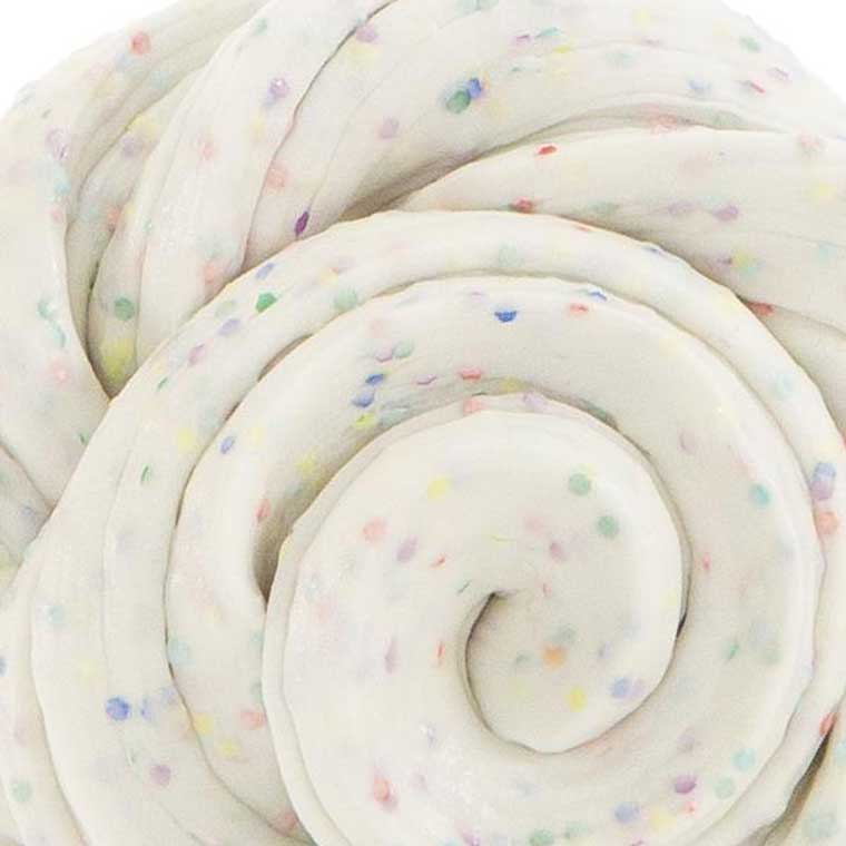 Close up texture of white putty with multicolor specs.