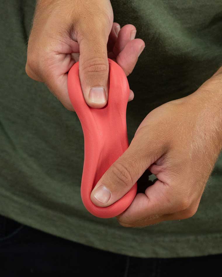 Two hands stretching red color putty.