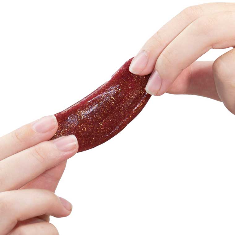 Two hands holding red sparkle putty.